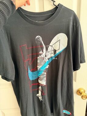 Nike Black Short-Sleeve Basketball Graphic Tee with Blue Swoosh and Red Accents